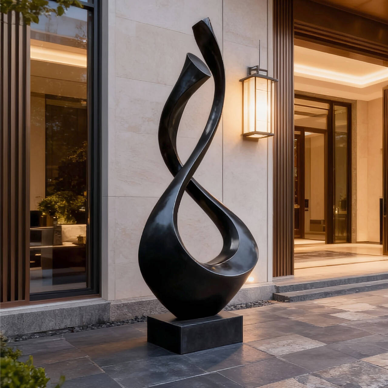 Black abstract sculpture in front of a building entrance