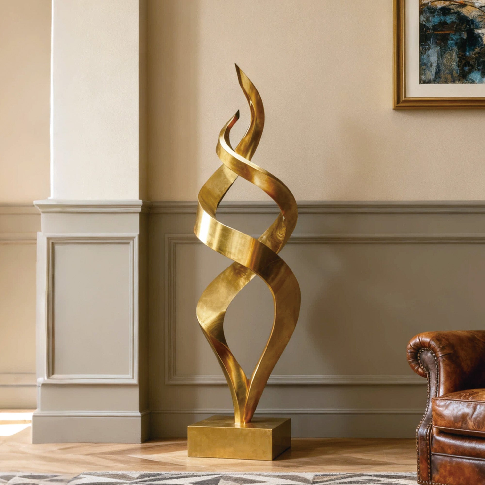 Gold abstract sculpture in a room with a chair and wall art