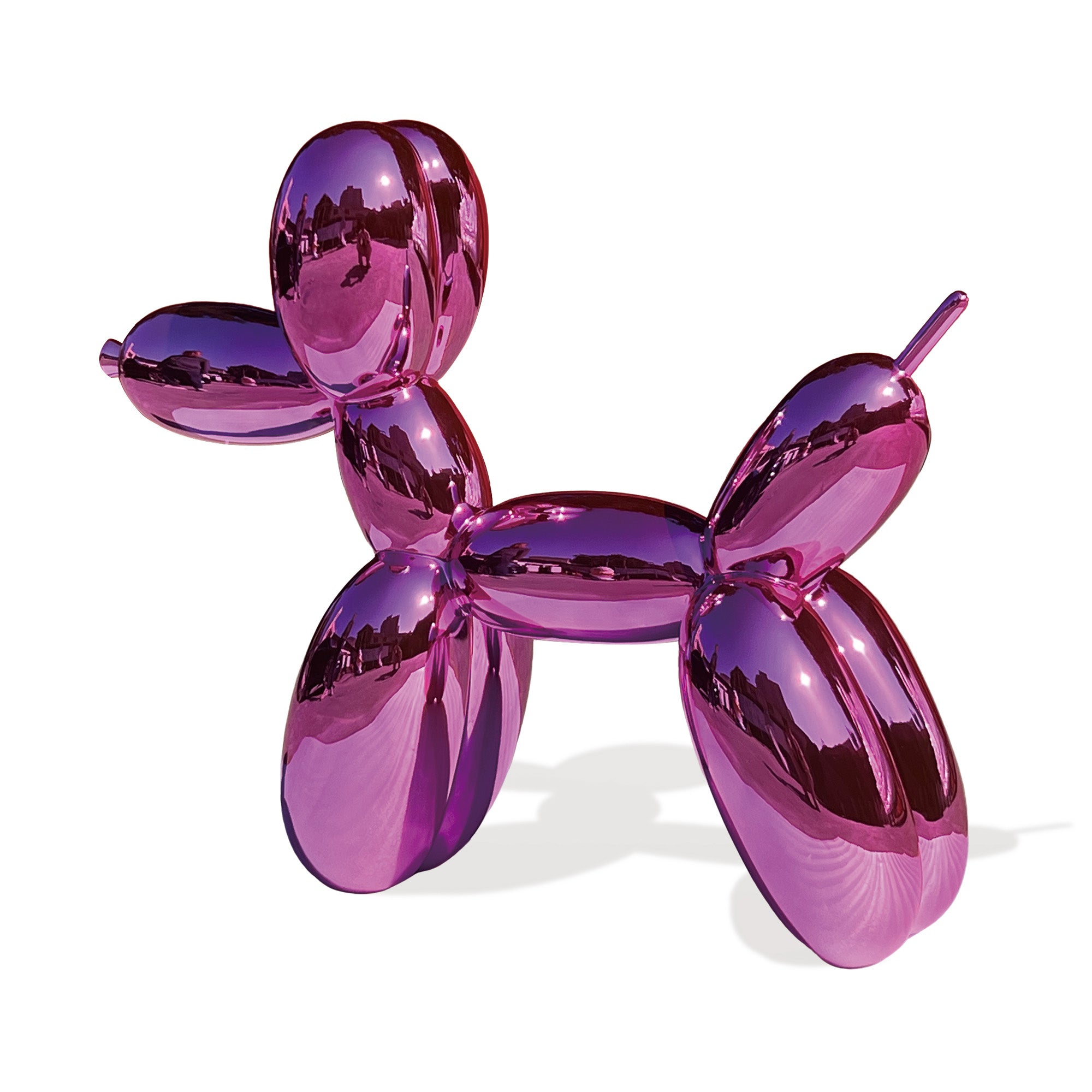 Pink balloon dog sculpture on a white background
