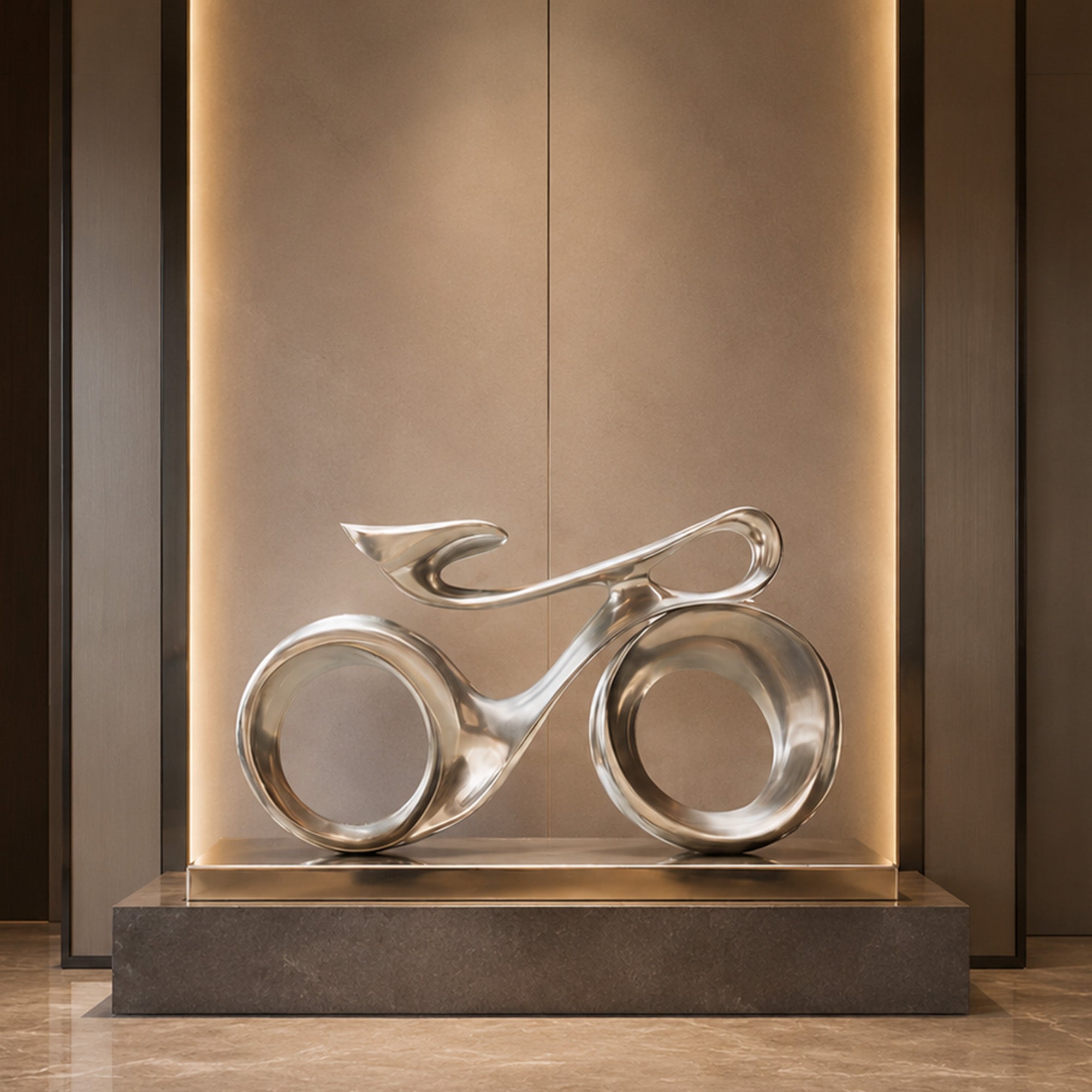 Modern bicycle-inspired stainless steel sculpture displayed in a luxury hotel lobby, featuring polished metal curves, circular wheel forms, and contemporary abstract design