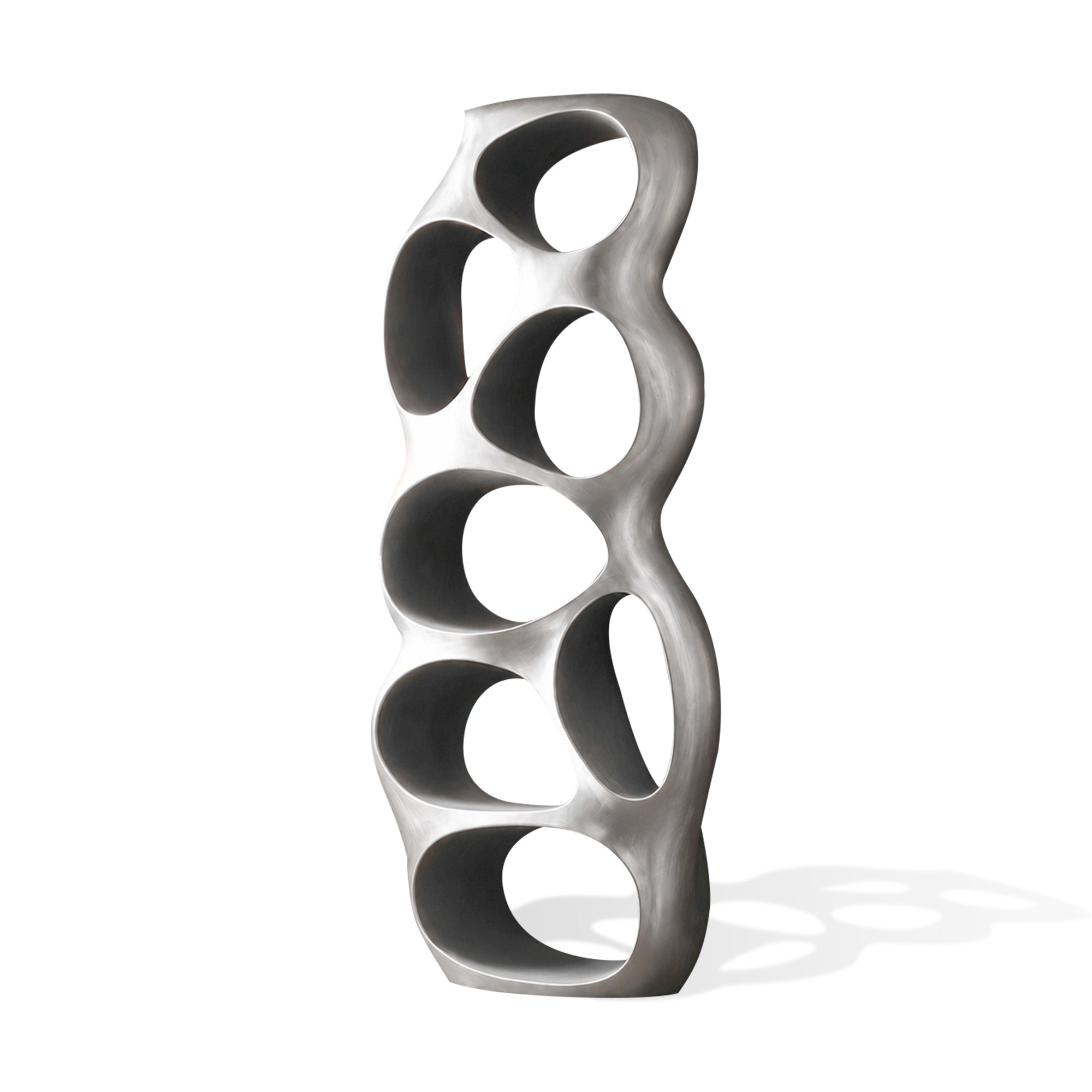 Front view of a brushed stainless steel organic display shelf with rounded open compartments, matte silver finish, and sculptural vertical form on a white background.