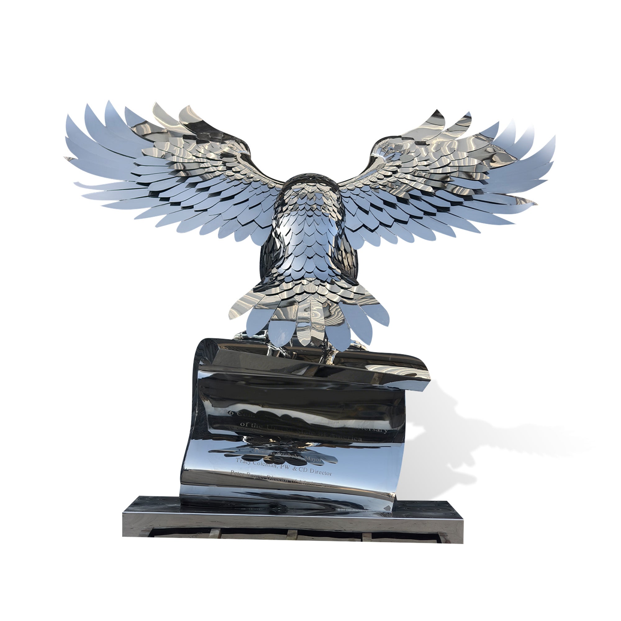 Mirror polished stainless steel eagle sculpture shown from the back, with wide spread wings, layered feather details, and a reflective scroll base