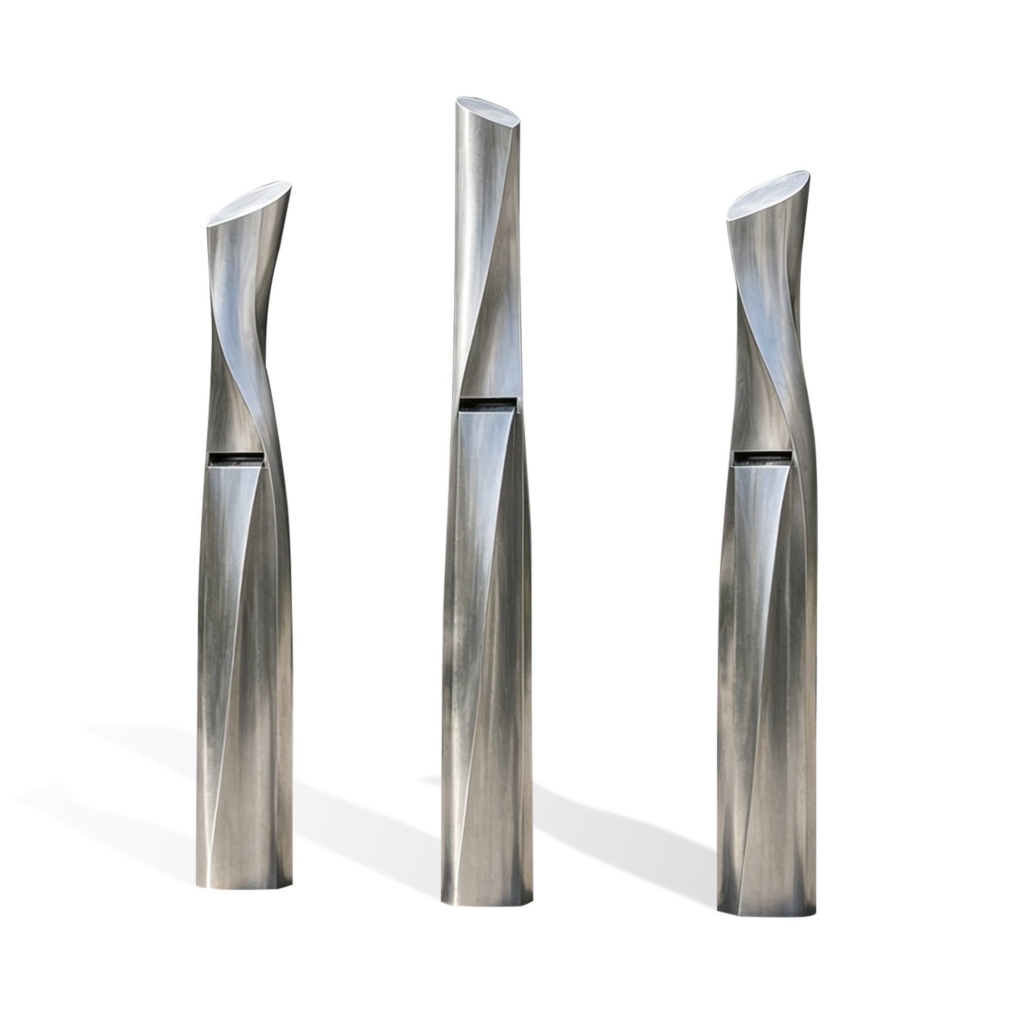 Three-piece brushed stainless steel column fountain set with slim twisting forms, angled open tops, rectangular water outlet slots, and modern outdoor water feature design on white background