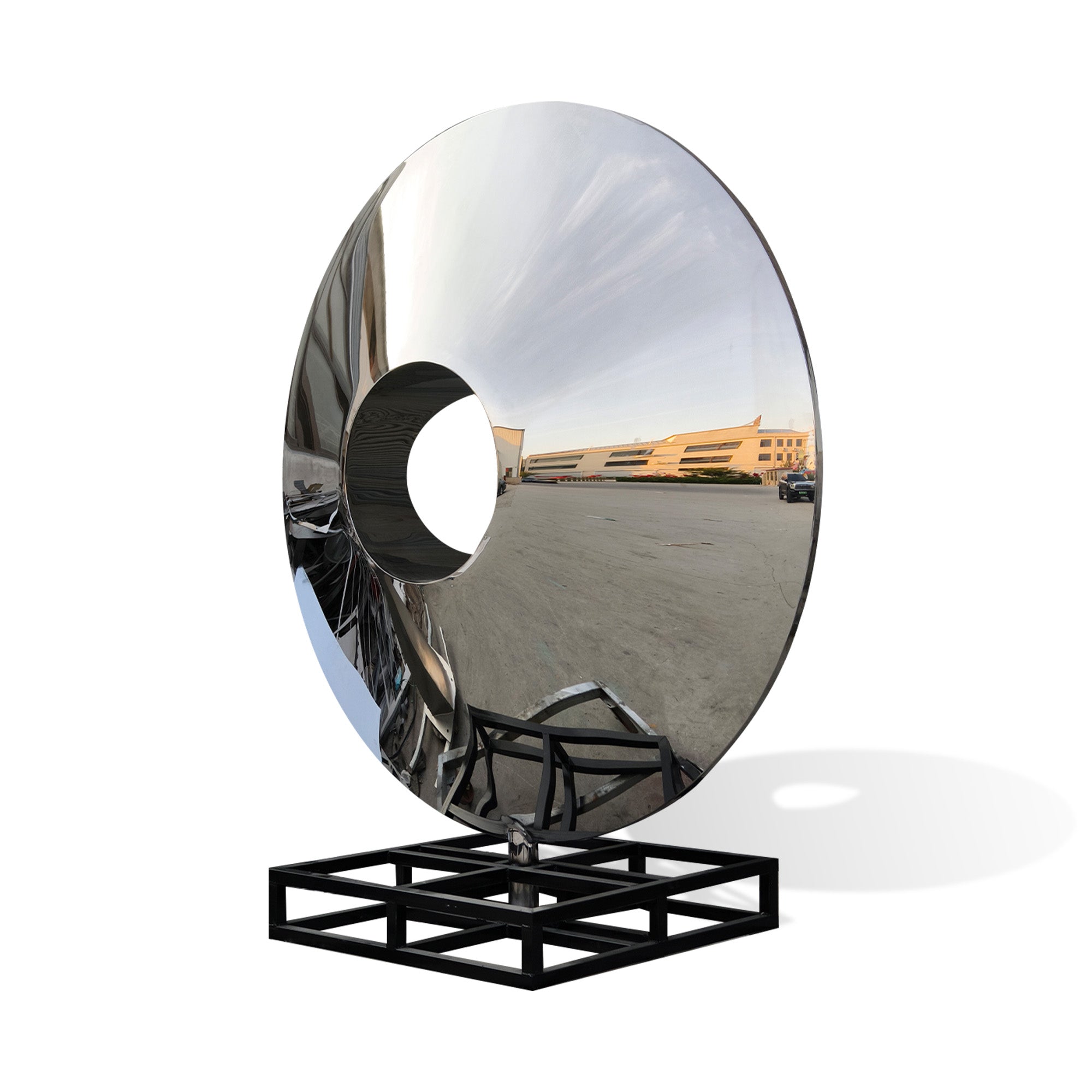 Sky Portal mirror stainless steel ring sculpture with polished circular form, central round opening, reflective surface, and black metal support frame on white background