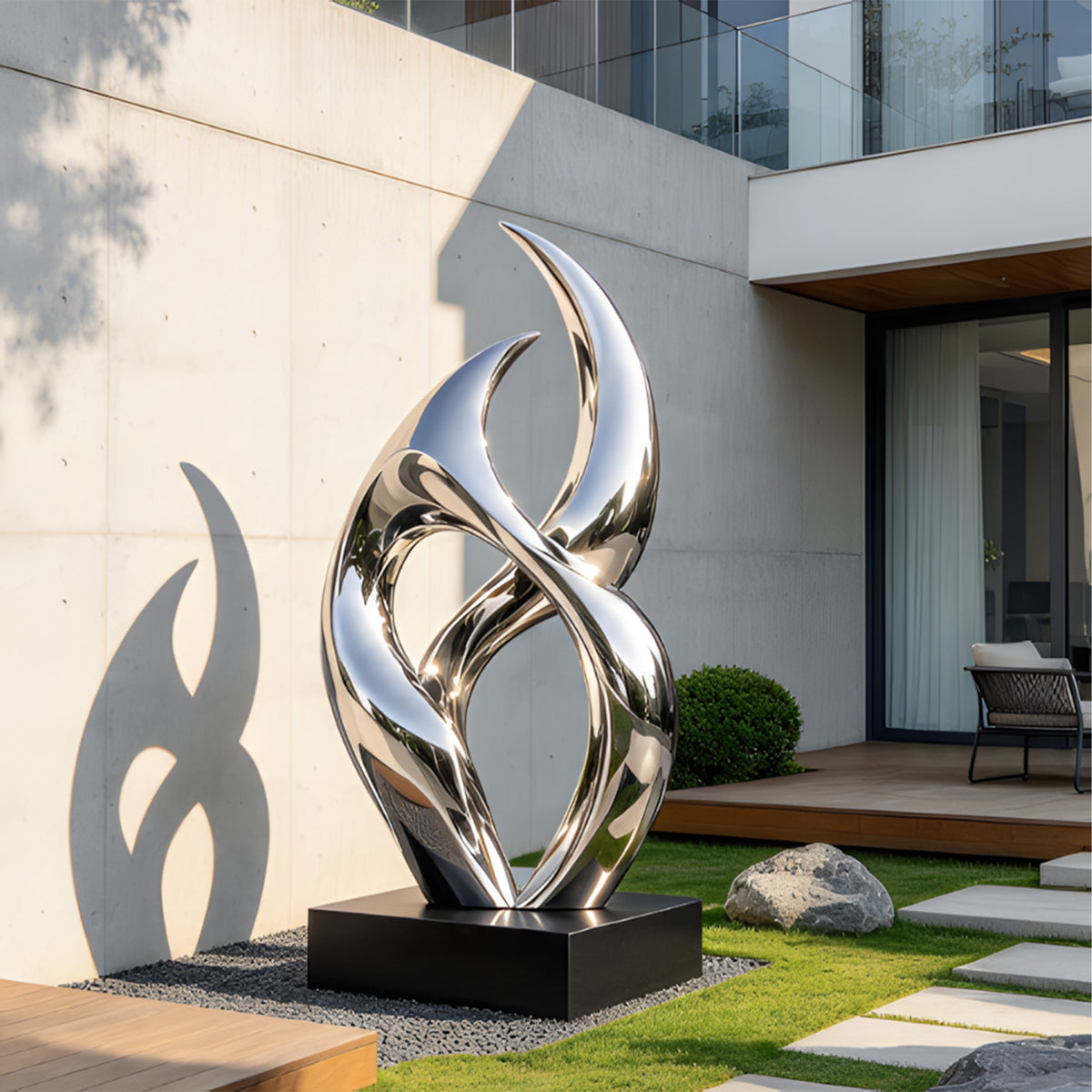 Modern mirrored stainless steel garden sculpture with twisting silver curves reflecting the surrounding greenery and landscape