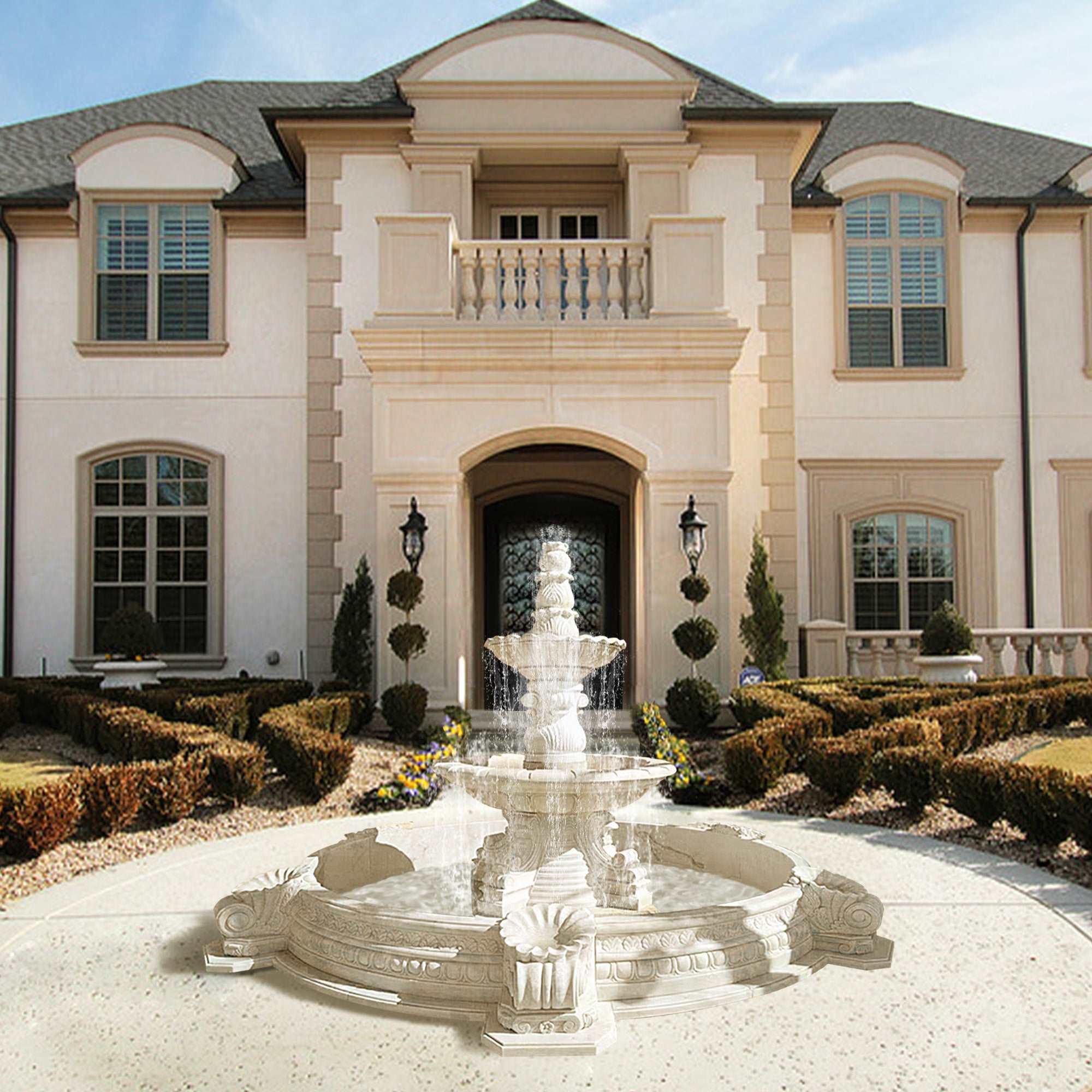 white marble fountain sculpture with living water in garden