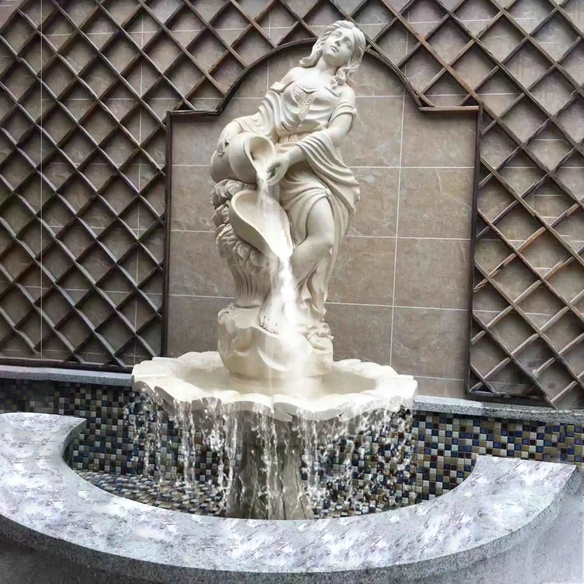 white marble fountain with a statue of a woman standing and pouring water from an urn