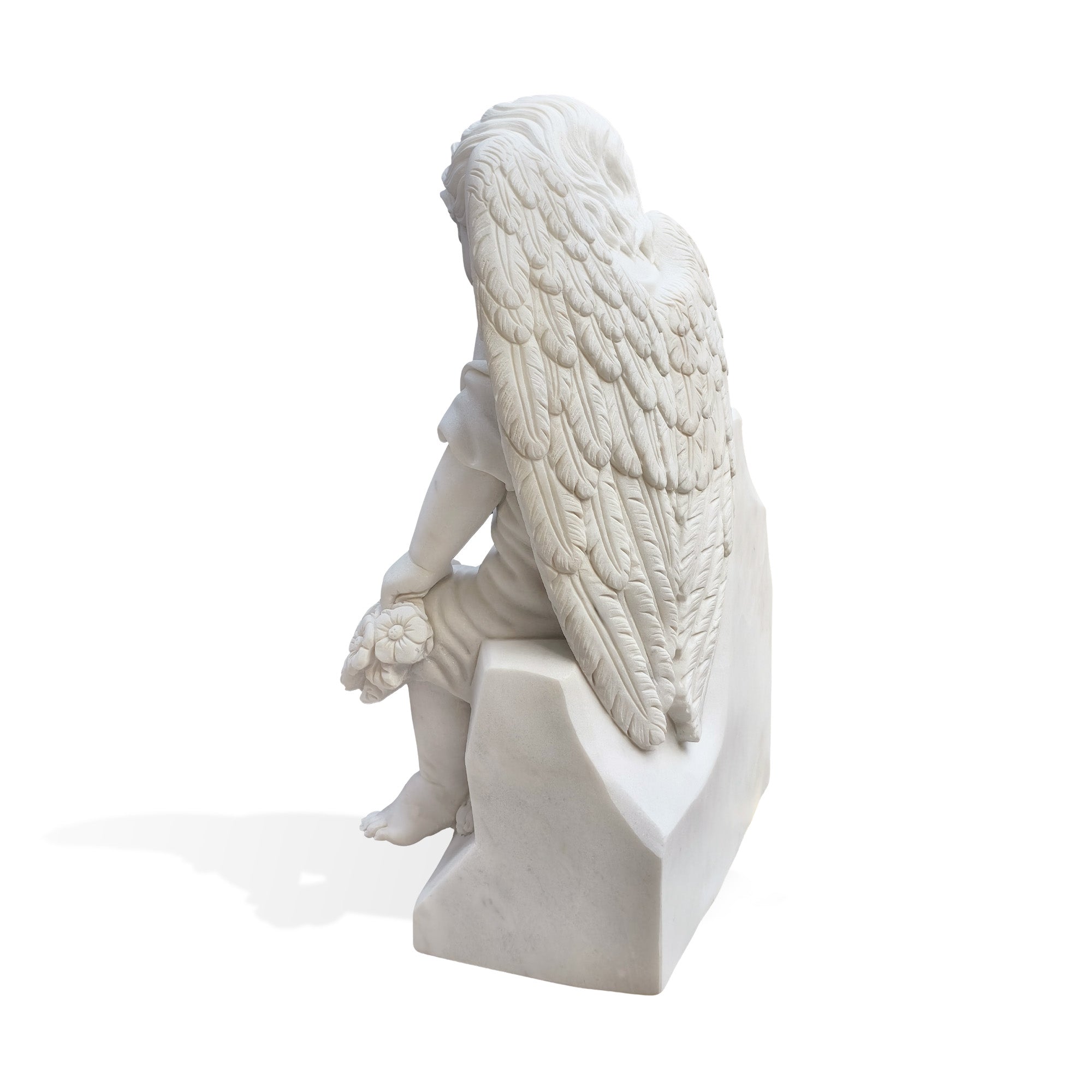 White marble angel statue showing detailed feathered wings and seated pose, suitable for cemetery memorials and garden monuments