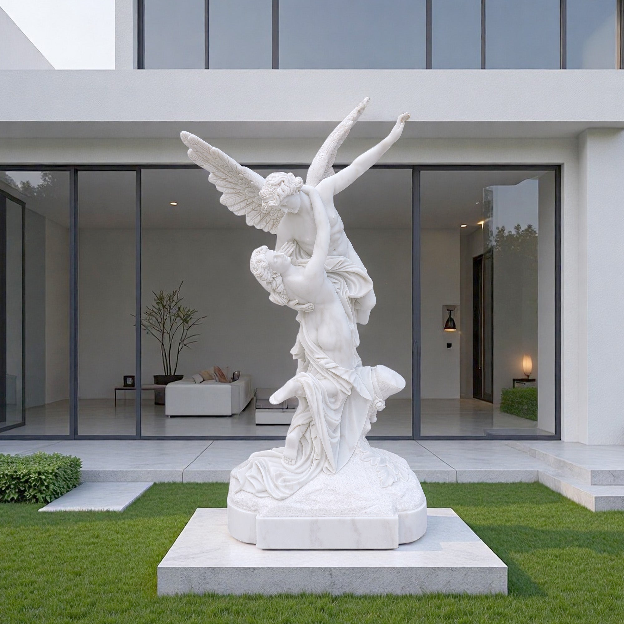 The large marble Cupid and Psyche statue installed outdoors in a modern garden setting on a stone base.