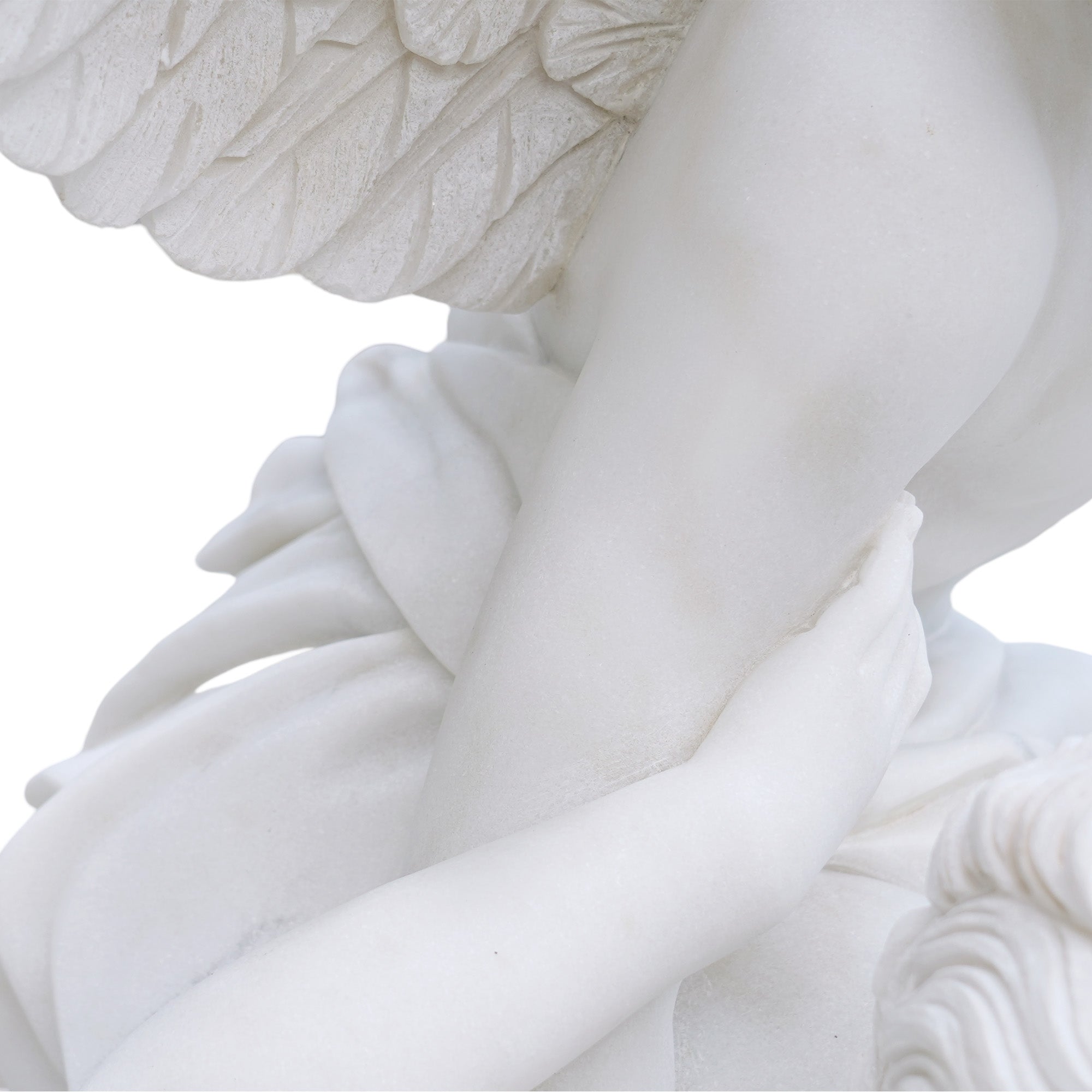 Close-up detail of Psyche’s hand resting on Cupid’s arm with wing carving visible in the background.