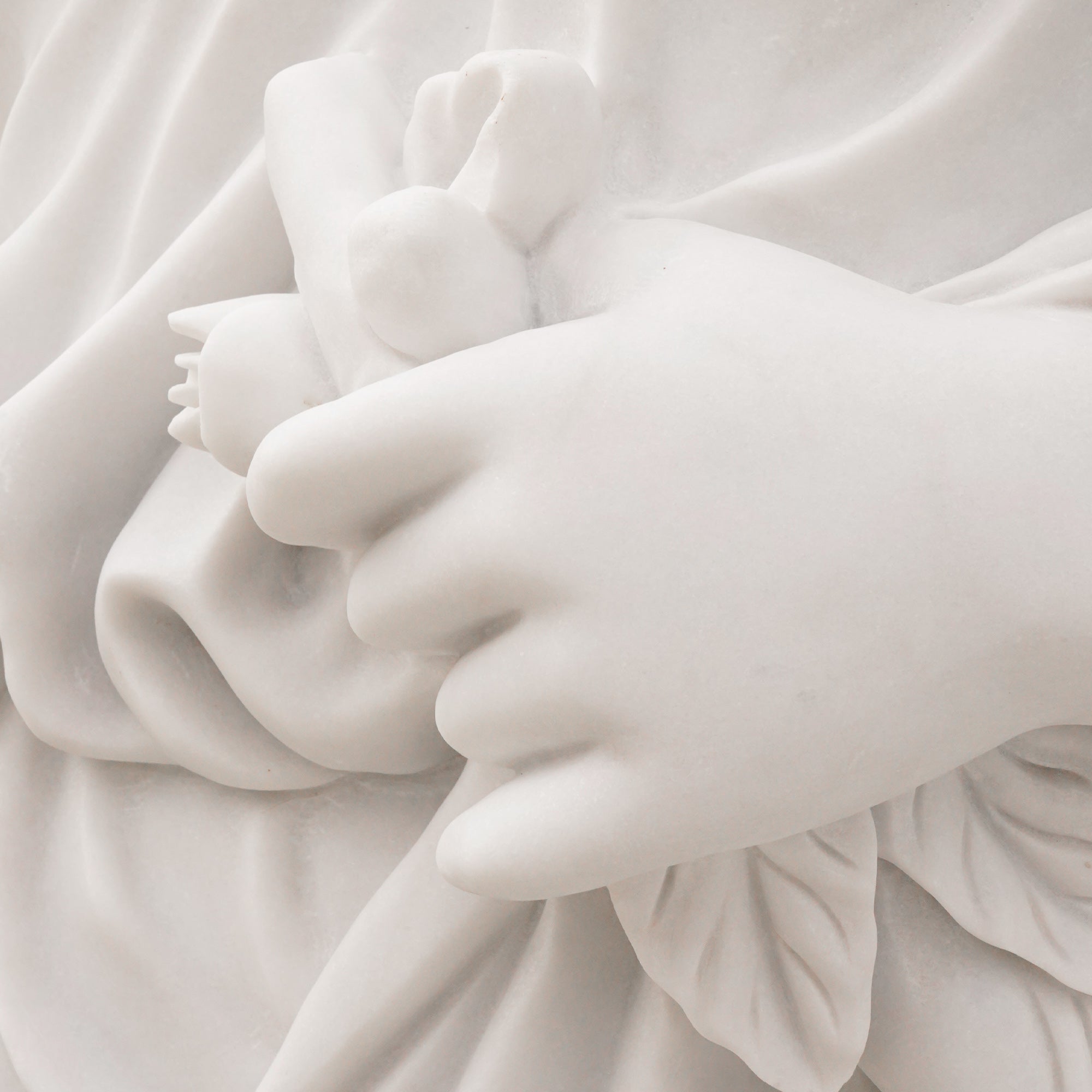 Hand detail from the Music and Inspiration marble replica, showing symbolic floral carving inspired by Bistolfi’s facade sculpture in Mexico City.