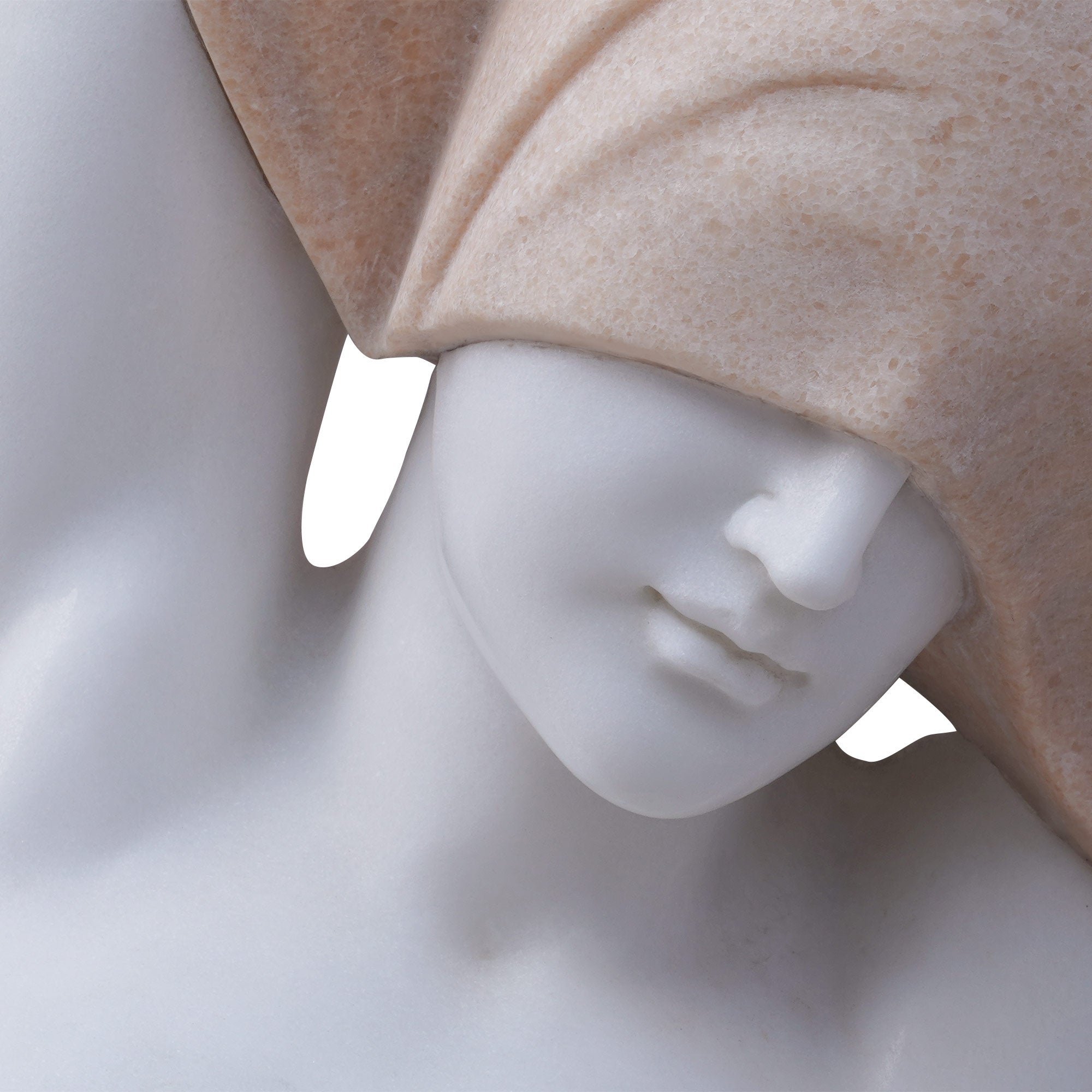 Close-up of Naked Woman sculpture, revealing delicate marble facial carving and the textured sesame red granite veil.