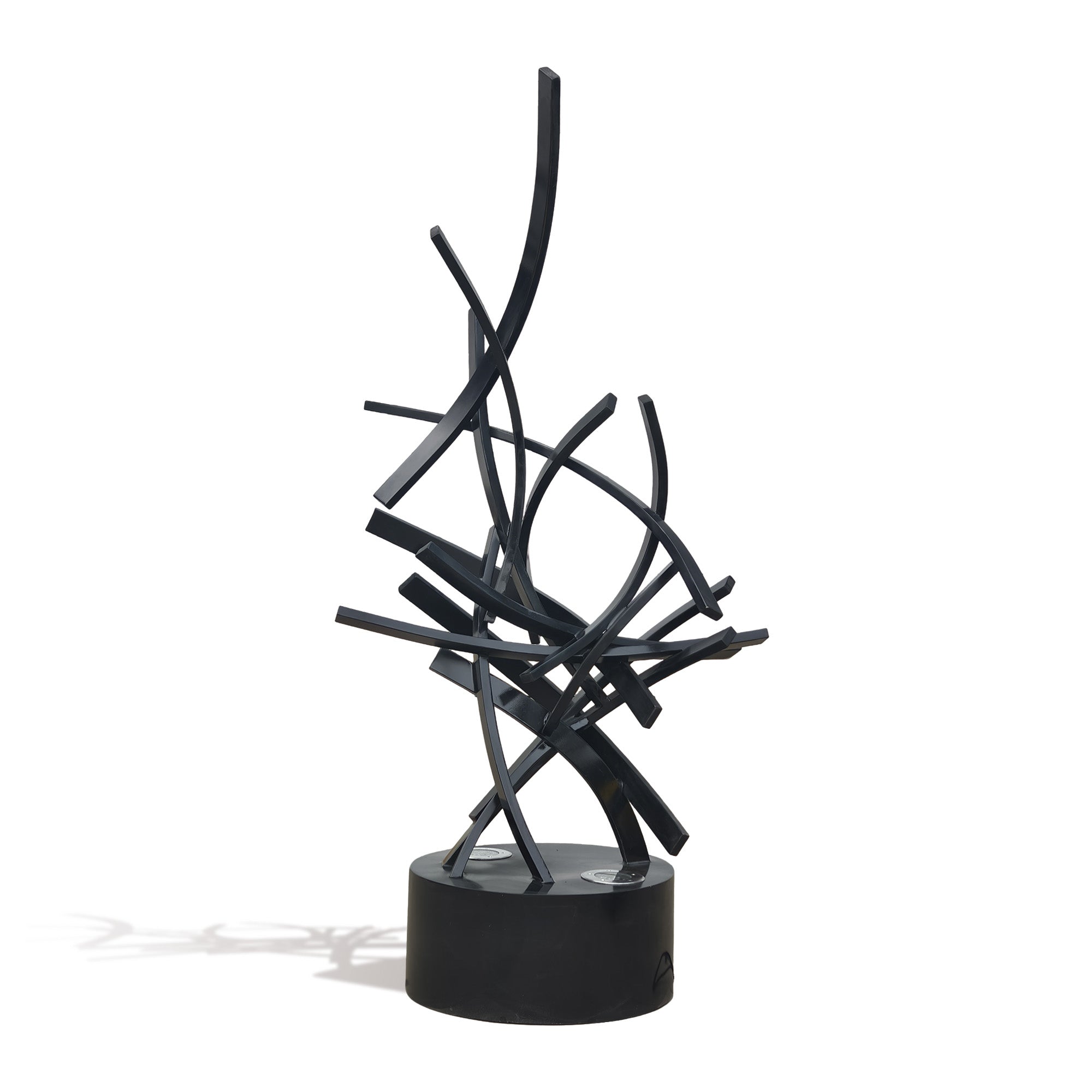 Side view of LED illuminated black stainless steel abstract light sculpture, contemporary ribbon form with integrated lighting for luxury interiors and gardens.