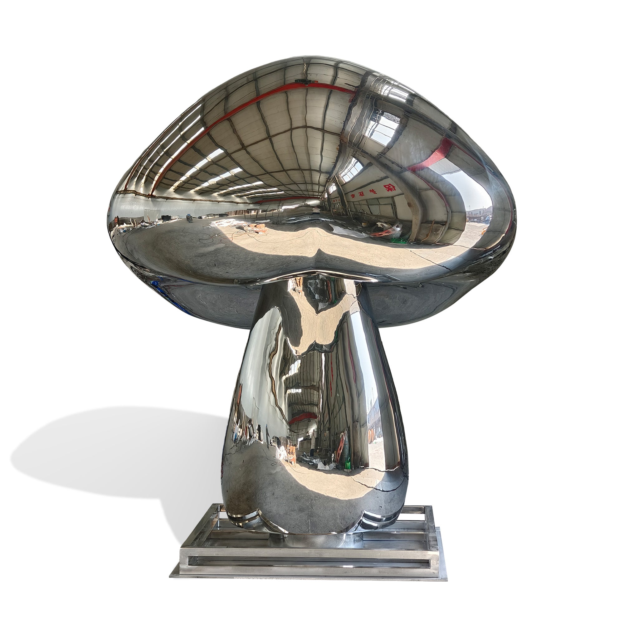 Angled view of mirror finish stainless steel mushroom outdoor sculpture, oversized lawn statement piece for public art and luxury landscapes.