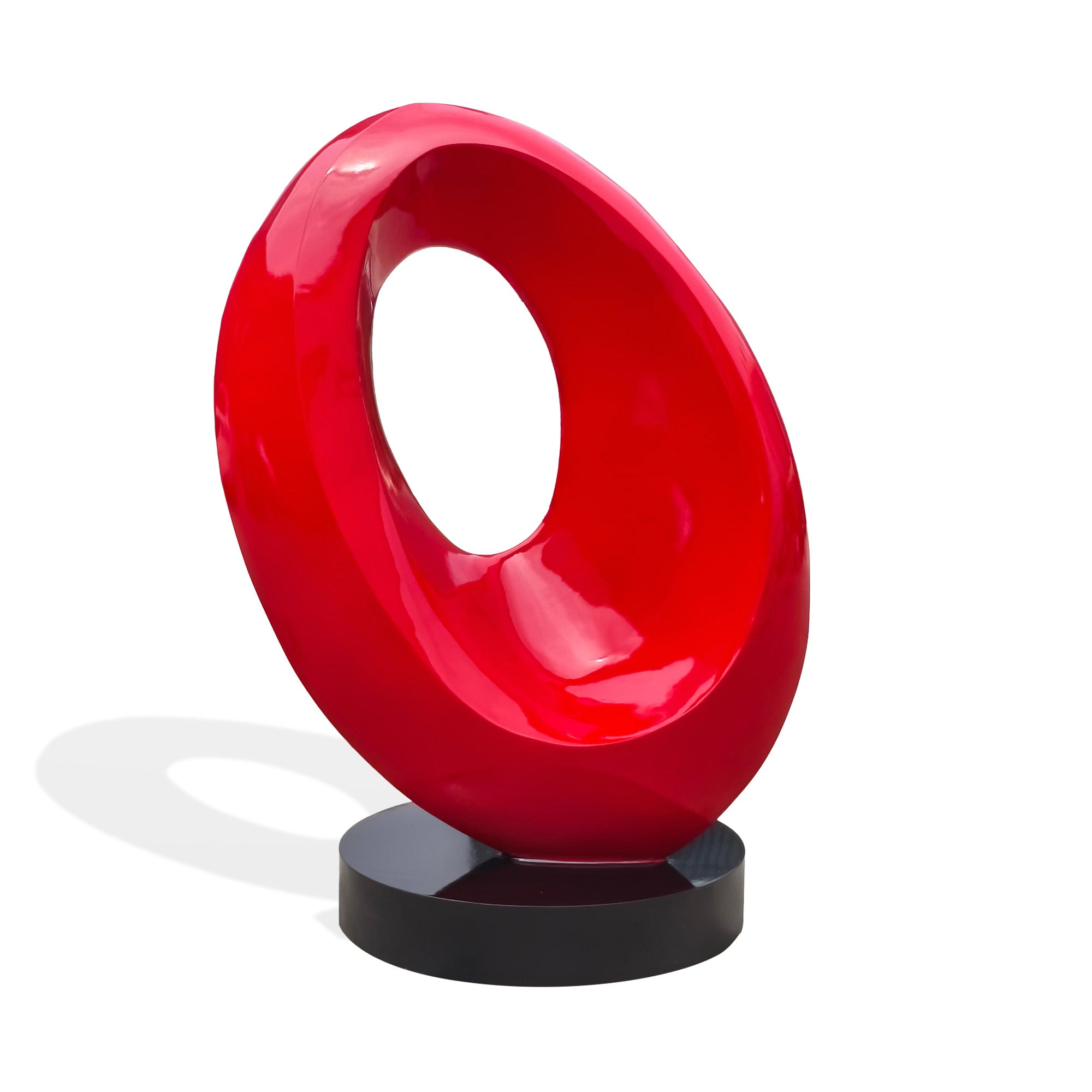 Front view of red painted stainless steel abstract loop sculpture with modern hollow center, contemporary art sculpture on round black base.