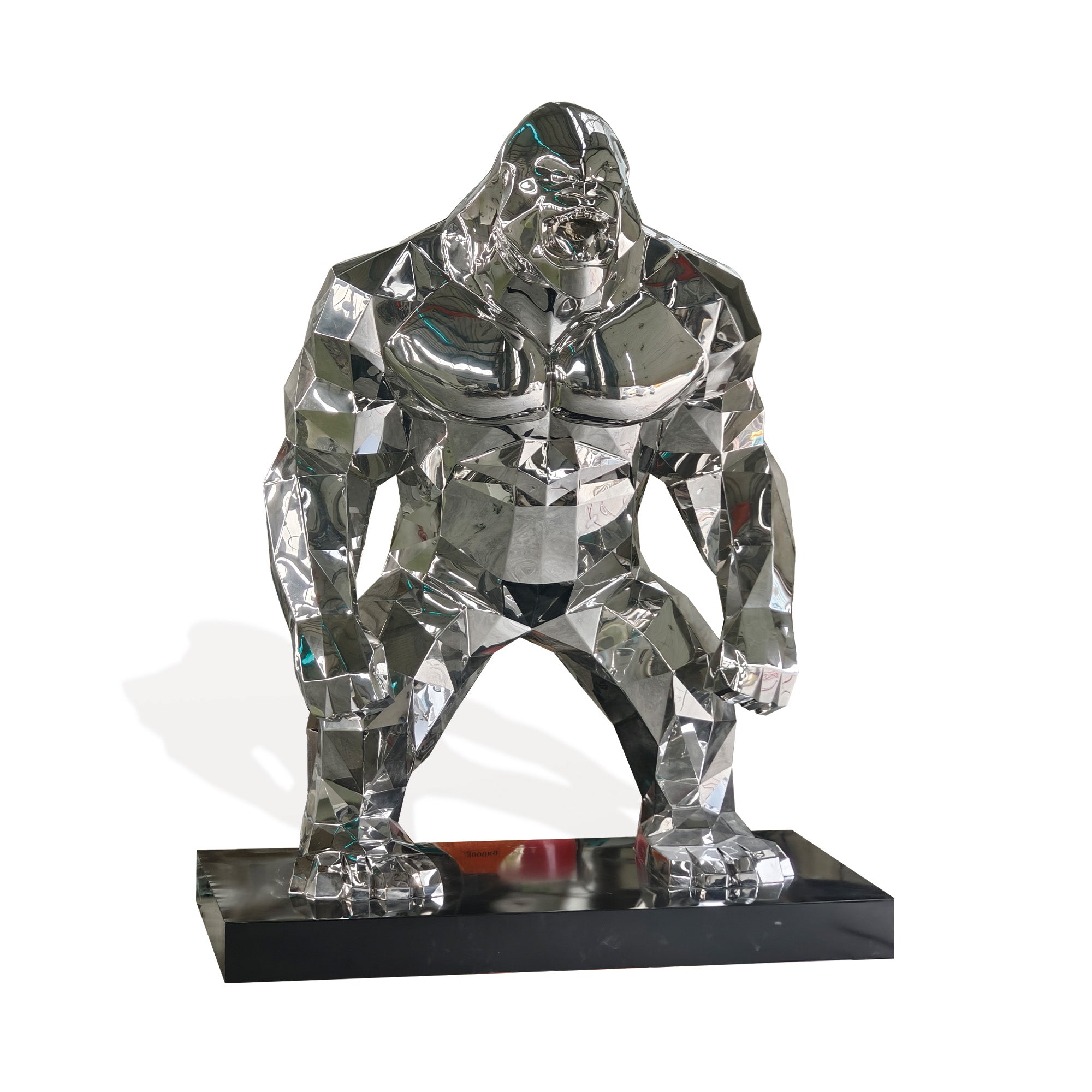 Life-size stainless steel gorilla sculpture with a mirror polished finish, featuring bold geometric shapes and sleek curves, perfect for luxury gardens, modern outdoor spaces, and high-end collections.