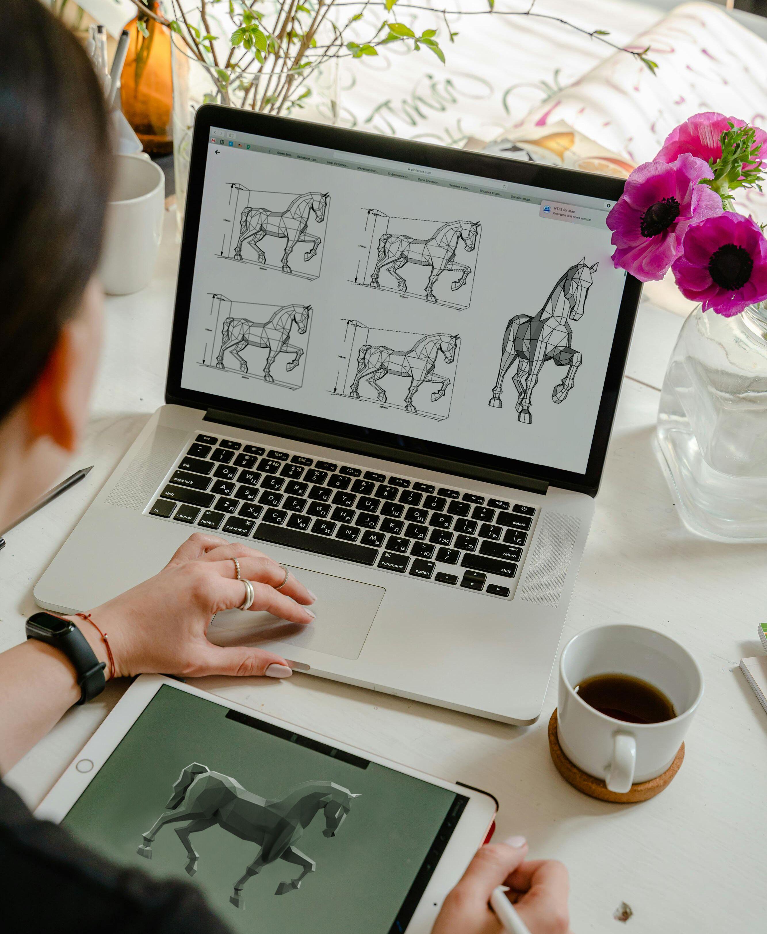 artist drawing on the computer for horse statue