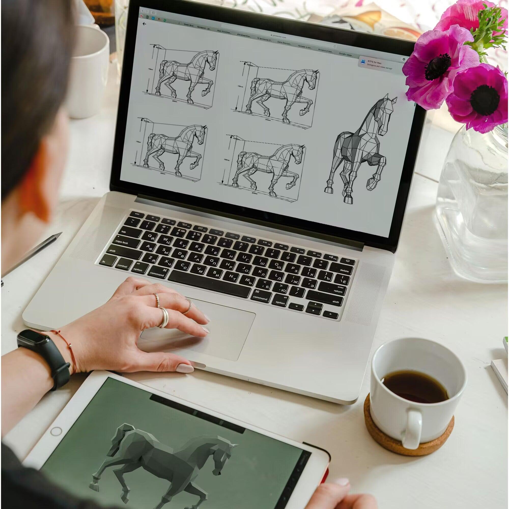 artist drawing on the computer for horse statue