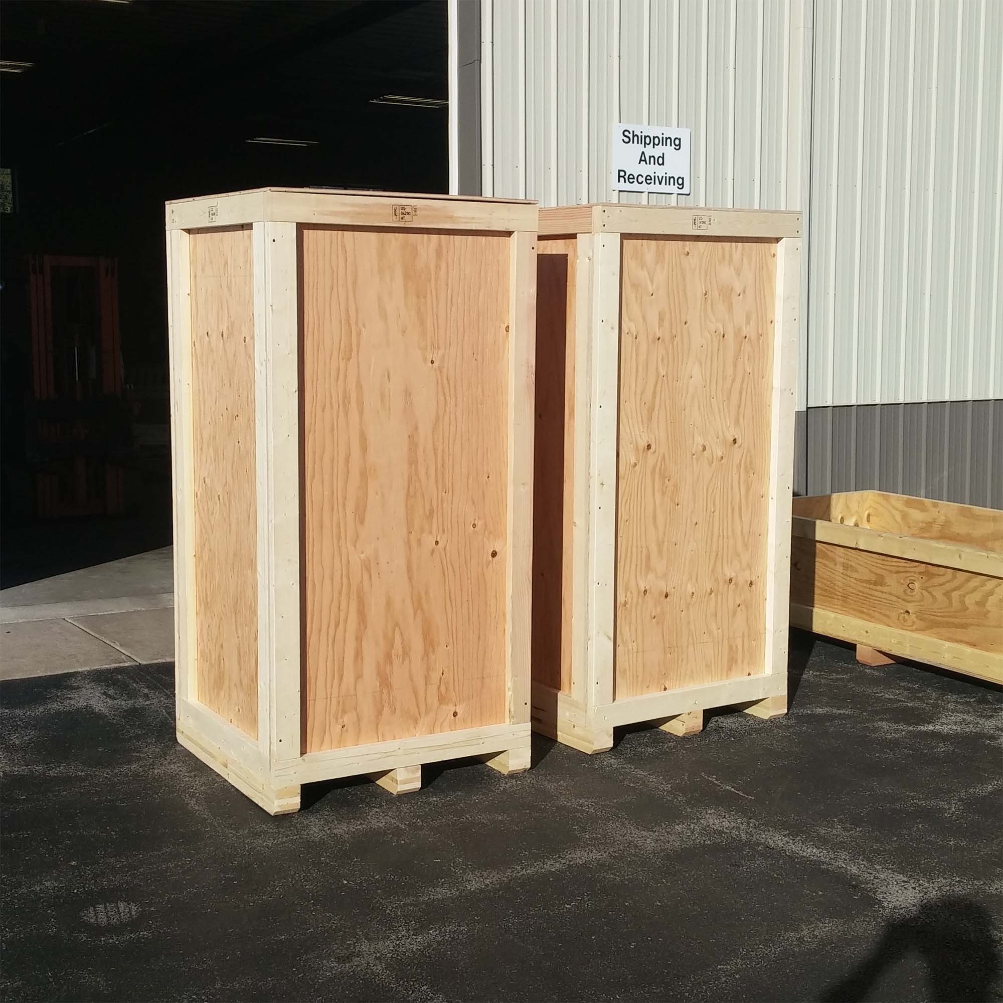 two wooden packages of statues at warehouse gate