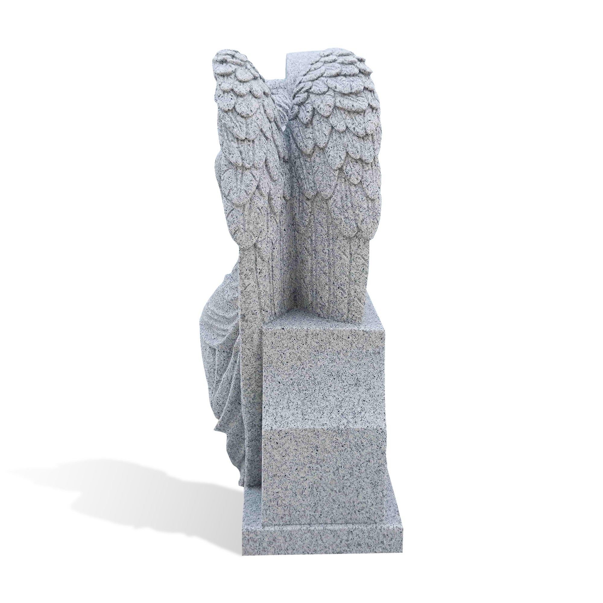 Angle view of the grey granite angel headstone highlighting the layered feather carving and flowing angel robe